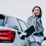 Woman charging her electric car